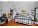 Bedroom with wood floors, a large window and a sliding barn door to the bathroom at 9176 Lakeview Parkway, Villa Rica, GA 30180