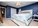 Cozy blue bedroom with a queen-sized bed, ceiling fan, closet, and natural light, offering a restful retreat at 9176 Lakeview Parkway, Villa Rica, GA 30180