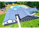Community clubhouse with a dark roof, light siding, manicured lawn, and a swimming pool in the background at 9176 Lakeview Parkway, Villa Rica, GA 30180