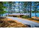 Lakeside view of the Dockside Marina Restaurant with a long private driveway surrounded by trees at 9176 Lakeview Parkway, Villa Rica, GA 30180