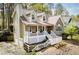 Two car garage and charming front porch featuring a stone and siding exterior at 9176 Lakeview Parkway, Villa Rica, GA 30180