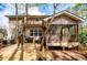 Backyard view of the home featuring a screened porch and wooden deck at 9176 Lakeview Parkway, Villa Rica, GA 30180