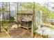 Two-story home with screened porch, deck, basketball hoop, and stone pathway near lake at 9176 Lakeview Parkway, Villa Rica, GA 30180