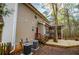 Two-story home featuring vinyl siding, deck, and porch nestled in a wooded area with a red door at 9176 Lakeview Parkway, Villa Rica, GA 30180