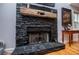 Stone fireplace with a wooden mantle and dark stones at 9176 Lakeview Parkway, Villa Rica, GA 30180