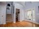 Bright foyer with hardwood floors, staircase, and access to outdoor deck at 9176 Lakeview Parkway, Villa Rica, GA 30180