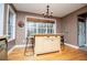 Charming kitchen island with seating and storage, illuminated by a chandelier, surrounded by natural light at 9176 Lakeview Parkway, Villa Rica, GA 30180