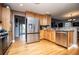 Kitchen with stainless steel appliances, wooden cabinets, granite countertops, and hardwood floors at 9176 Lakeview Parkway, Villa Rica, GA 30180