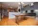 Bright living room featuring hardwood floors, a large dining table, and an open-concept kitchen and living area at 9176 Lakeview Parkway, Villa Rica, GA 30180