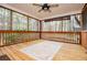 Relaxing screened porch with wood floors and ceiling fan overlooking a lush backyard at 9176 Lakeview Parkway, Villa Rica, GA 30180