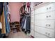 Organized walk-in closet with built-in shelving, hanging racks, and drawers for ample storage solutions at 9176 Lakeview Parkway, Villa Rica, GA 30180