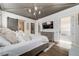 Spacious main bedroom features a decorative ceiling, hardwood floors, and a barn door to the bathroom at 00 Daxton Dr (Lot 74), Canton, GA 30115