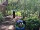 Charming backyard featuring a bird bath, mature plantings, and a variety of potted plants adding color and interest at 3259 Clairmont North Ne, Brookhaven, GA 30329