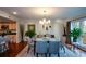Dining area with hardwood floors, chandelier, and kitchen in background at 3259 Clairmont North Ne, Brookhaven, GA 30329