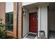 Charming entryway features a red door and manicured landscaping at 3259 Clairmont North Ne, Brookhaven, GA 30329