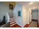 Hallway featuring a staircase, hardwood floors, neutral paint, and updated lighting fixtures at 3259 Clairmont North Ne, Brookhaven, GA 30329