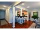Open concept living area featuring a bar, modern stools, and hardwood flooring at 3259 Clairmont North Ne, Brookhaven, GA 30329