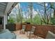 An outdoor patio featuring brick walls, tiled flooring, and serene wooded views at 3259 Clairmont North Ne, Brookhaven, GA 30329