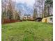 Lush backyard with trees, a shed, and deck, perfect for relaxation or outdoor activities at 3991 Centennial Trl, Duluth, GA 30096