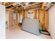 Unfinished basement featuring open beams and a single window, awaiting your custom design at 3991 Centennial Trl, Duluth, GA 30096