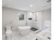 Modern bathroom featuring a soaking tub, glass-enclosed shower with marble tile, and a double sink vanity at 3991 Centennial Trl, Duluth, GA 30096