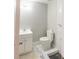 Bathroom featuring a marble tiled shower, toilet, and vanity with modern fixtures at 3991 Centennial Trl, Duluth, GA 30096