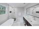 Bright bathroom with double sink vanity, tub, walk in shower and modern finishes at 3991 Centennial Trl, Duluth, GA 30096