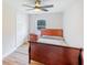 Cozy bedroom with wood flooring, a ceiling fan, closet, and a window providing natural light at 3991 Centennial Trl, Duluth, GA 30096