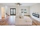 Bright living room featuring modern fireplace, hardwood floors, and ornate glass doors at 3991 Centennial Trl, Duluth, GA 30096