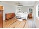 Spacious bedroom with hardwood floors, two windows, and ceiling fan at 3991 Centennial Trl, Duluth, GA 30096