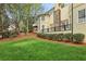 Well-manicured backyard with lush lawn, mature trees, and view of the home's exterior at 535 Telford Pl, Atlanta, GA 30342