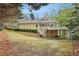 Extensive backyard featuring a lush lawn, mature trees, and a rear view of the home at 535 Telford Pl, Atlanta, GA 30342