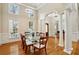 Elegant dining room with hardwood floors, columns, and modern light fixture at 535 Telford Pl, Atlanta, GA 30342