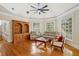 Comfortable living room with a ceiling fan, two large windows, wood floors and comfortable seating at 535 Telford Pl, Atlanta, GA 30342