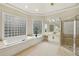Serene bathroom featuring a soaking tub, glass block windows, and walk-in shower at 535 Telford Pl, Atlanta, GA 30342