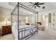 Spacious main bedroom with a tray ceiling, fan, and neutral decor at 535 Telford Pl, Atlanta, GA 30342