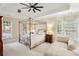 Bright main bedroom with a tray ceiling, fan, and neutral decor at 535 Telford Pl, Atlanta, GA 30342