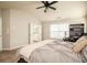 Bright bedroom featuring a neutral color palette, carpeted floors, and a ceiling fan with an adjacent bathroom at 246 Cavendar Way # 16, Marietta, GA 30066