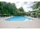 Sparkling community pool surrounded by ample seating, lush greenery, and offering a perfect spot for relaxation and recreation at 246 Cavendar Way # 16, Marietta, GA 30066