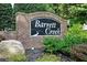Entrance sign to Barrett Creek community featuring brick base, attractive landscaping, and a decorative black and white sign at 246 Cavendar Way # 16, Marietta, GA 30066