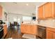 Kitchen view with stainless steel appliances, wood cabinets, and an adjacent dining area at 246 Cavendar Way # 16, Marietta, GA 30066