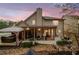 Back exterior featuring a covered patio, hot tub and ample yard space. Perfect for outdoor entertaining at 251 Manous Way, Canton, GA 30115