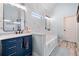 Bright bathroom featuring a modern vanity, soaking tub, and stylish marble wall tiles at 251 Manous Way, Canton, GA 30115