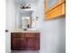 Simple bathroom featuring a vanity sink, mirror, and wall storage cabinet at 251 Manous Way, Canton, GA 30115