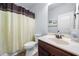Clean bathroom featuring a vanity sink, toilet, and shower with a shower curtain at 251 Manous Way, Canton, GA 30115