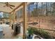 Covered patio featuring a ceiling fan, grill, landscaping, and backyard view at 251 Manous Way, Canton, GA 30115
