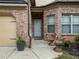 Inviting front entrance with brick facade, cozy seating area, and an attached two car garage at 251 Manous Way, Canton, GA 30115