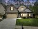 Charming two-story brick home featuring a well-manicured lawn and inviting curb appeal with an attached two car garage at 251 Manous Way, Canton, GA 30115