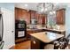 Well-appointed kitchen with dark wood cabinetry and stainless steel appliances at 251 Manous Way, Canton, GA 30115