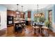 Open kitchen featuring an island with seating, wood cabinets, stainless steel appliances, and a bright breakfast nook at 251 Manous Way, Canton, GA 30115
